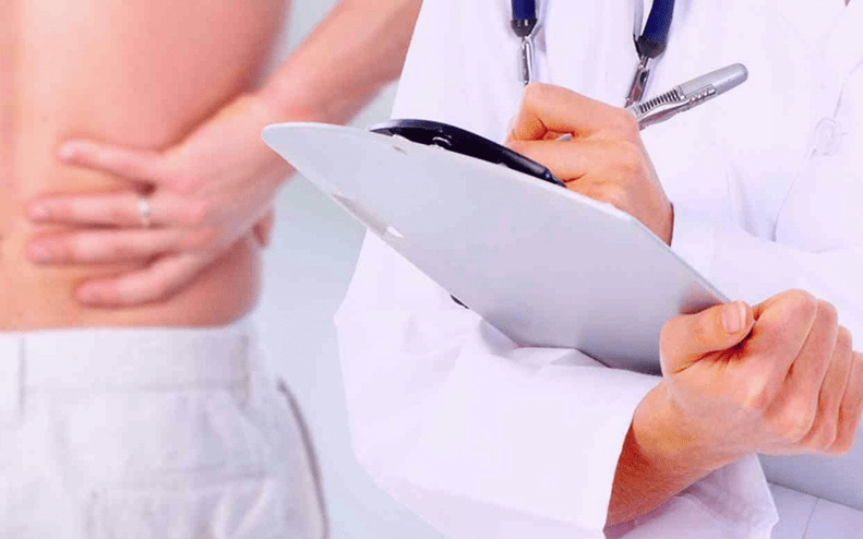 a doctor prescribes treatment for lower back pain